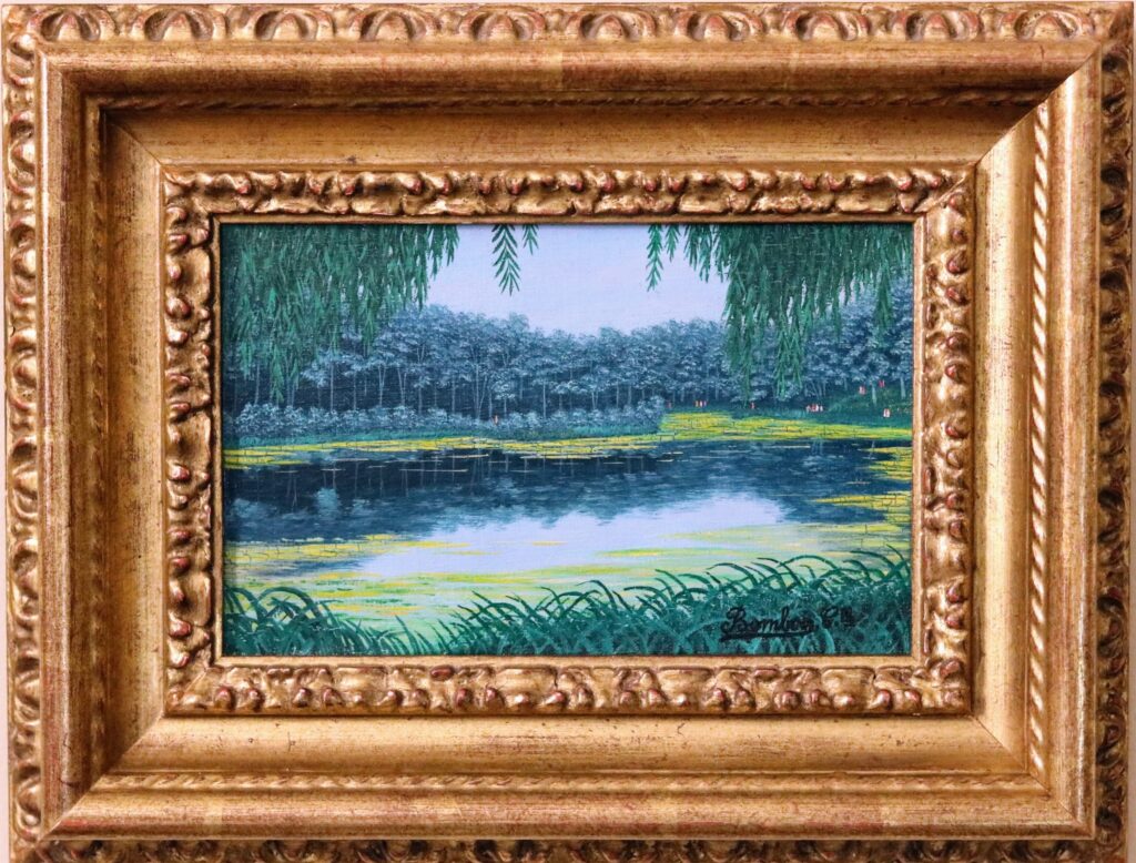 River Scene by Camille Bombois, featuring a calm river, dense forest reflections, and golden grasses along the water’s edge.